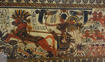 A painting of King Tut in his chariot.